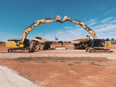 Commercial Grading — Two Yellow Excavation Truck in Gainesville, GA