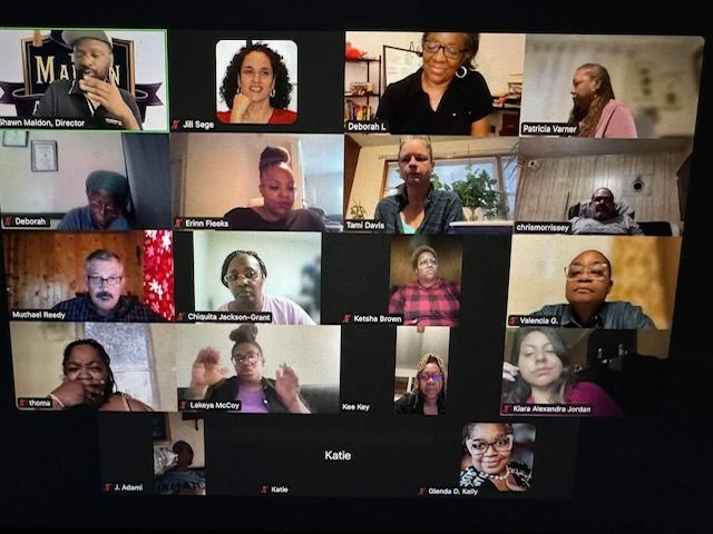 Group video conference of diverse people in separate windows.