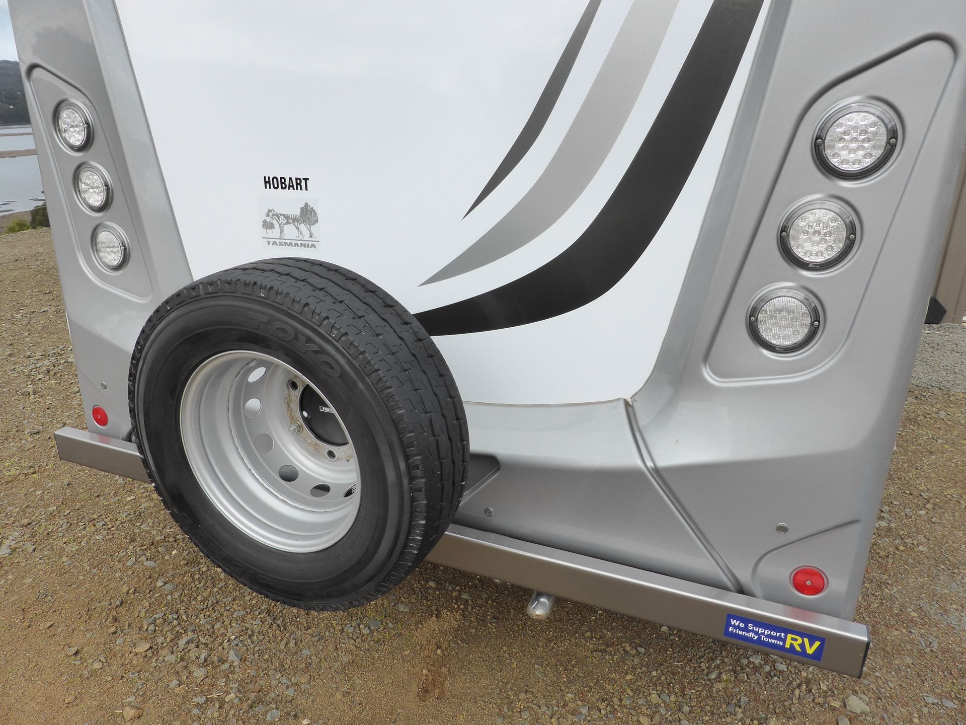 A tyre is attached to the back of a trailer.