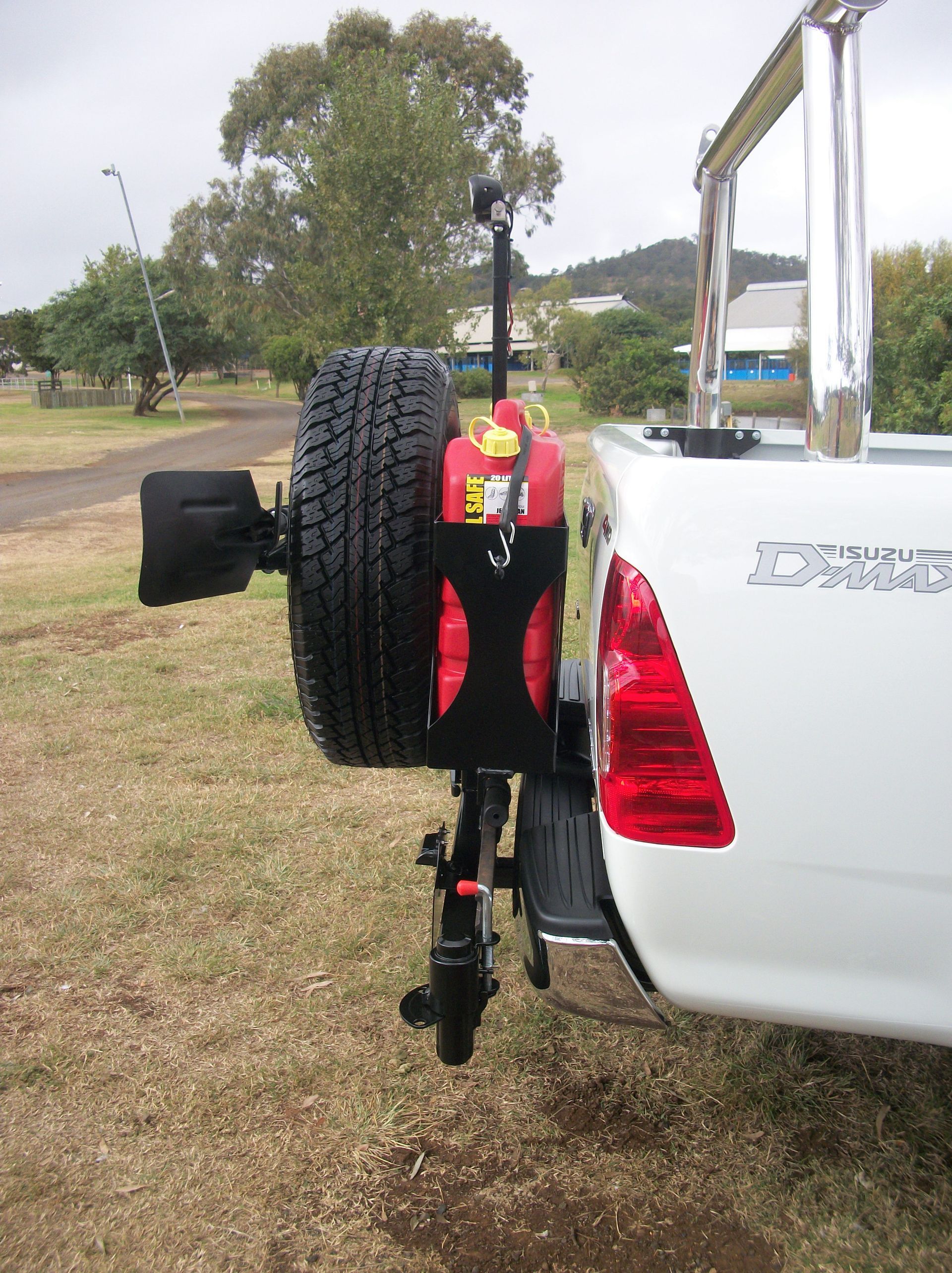 A white 4WD with a spare tyre attached to the back