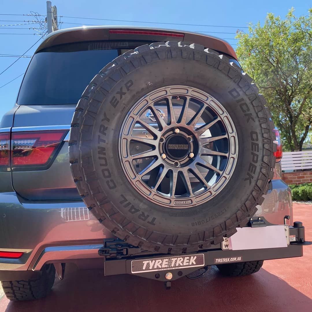 A car with a spare tyre attached to the back of it