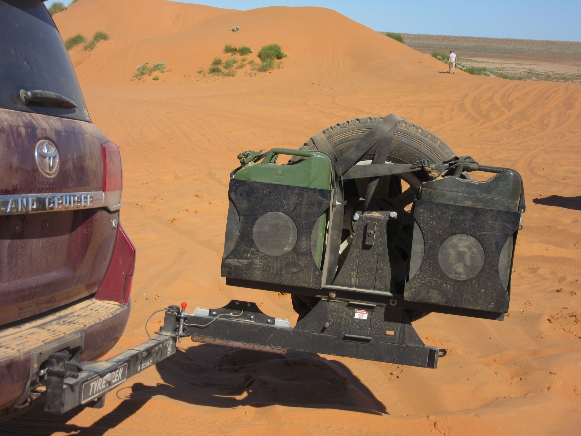 A car with a tyre rack and the word range rover written on the back