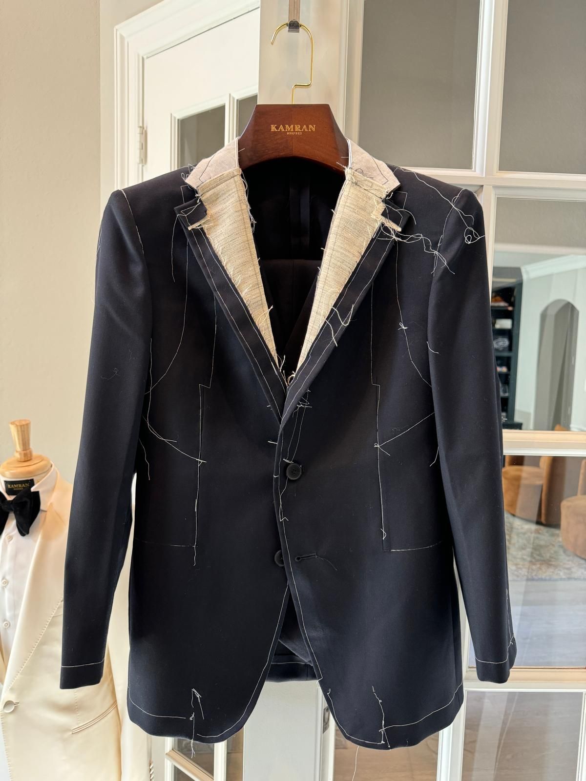 Kamran Bespoke navy skeleton jacket on tailor hanger