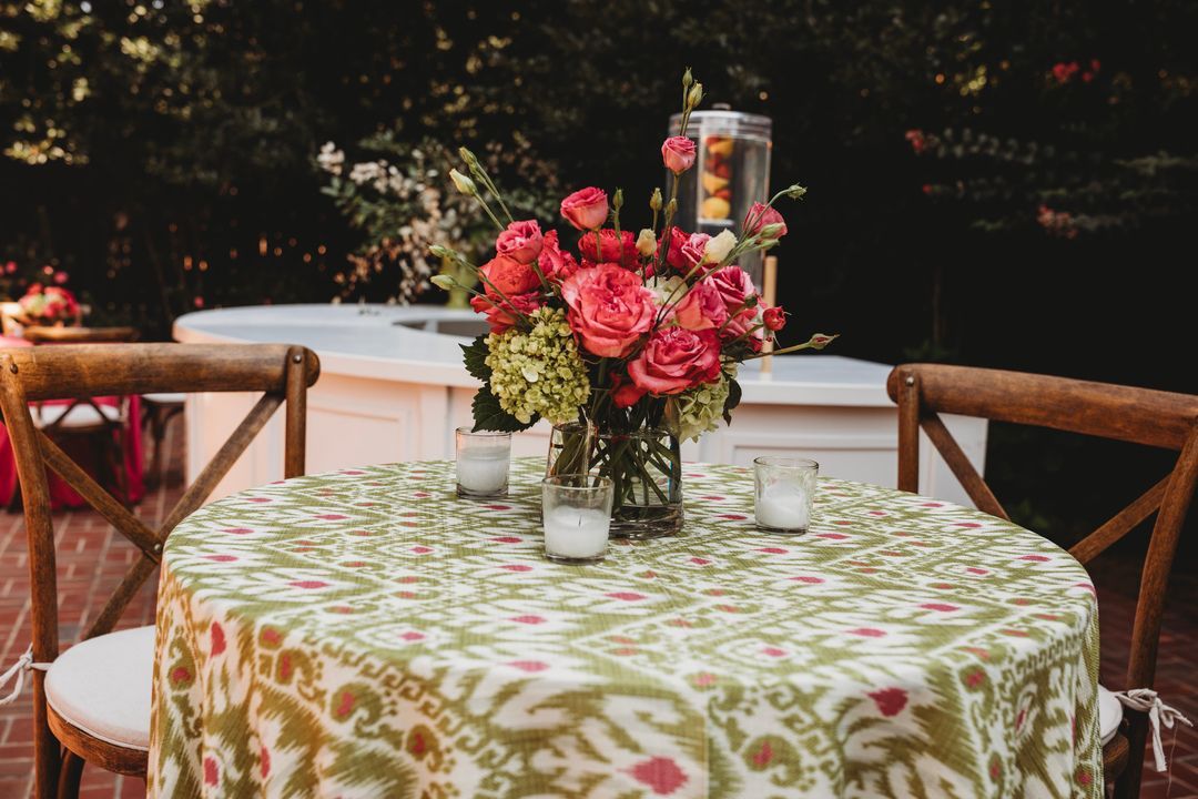 patterned tablecloth with pink florals and a bar and beverage dispenser