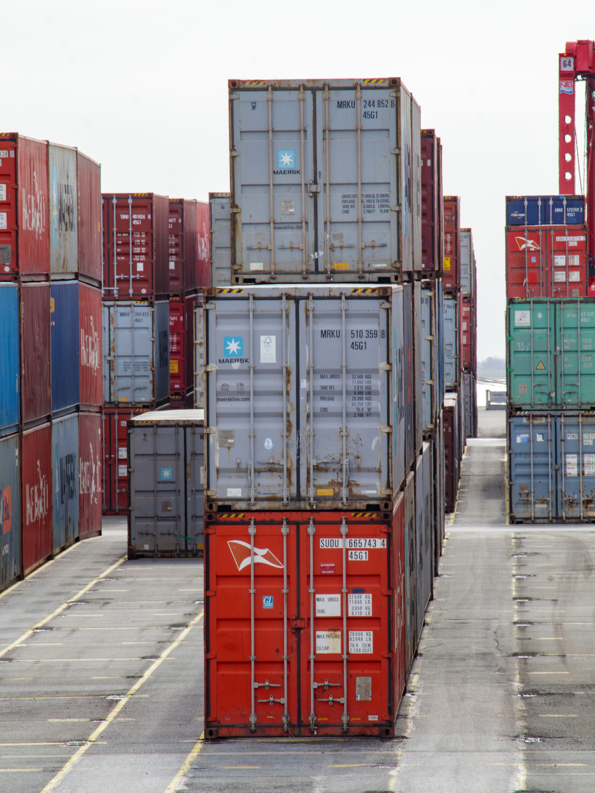 A bunch of shipping containers are stacked on top of each other