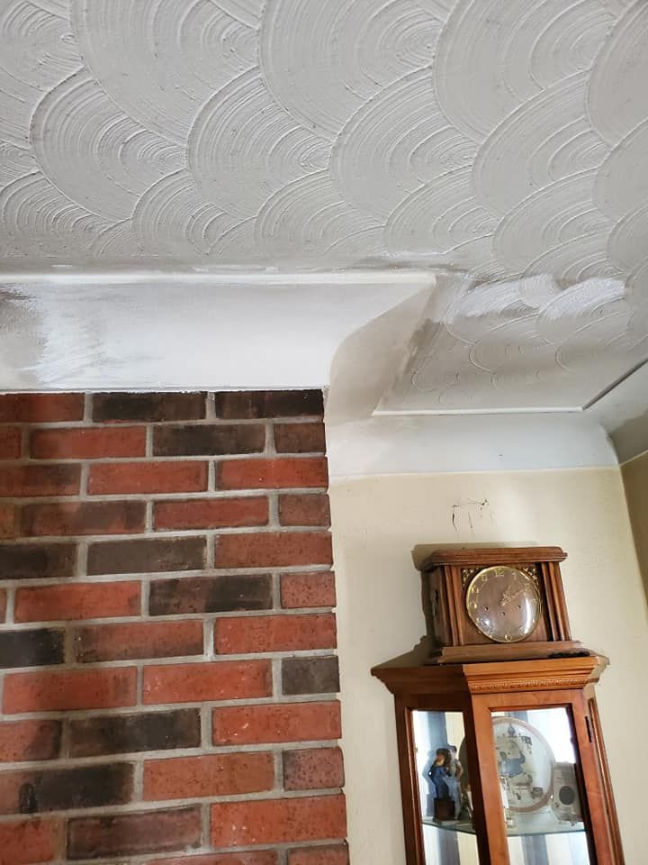 A living room with a clock and a brick wall