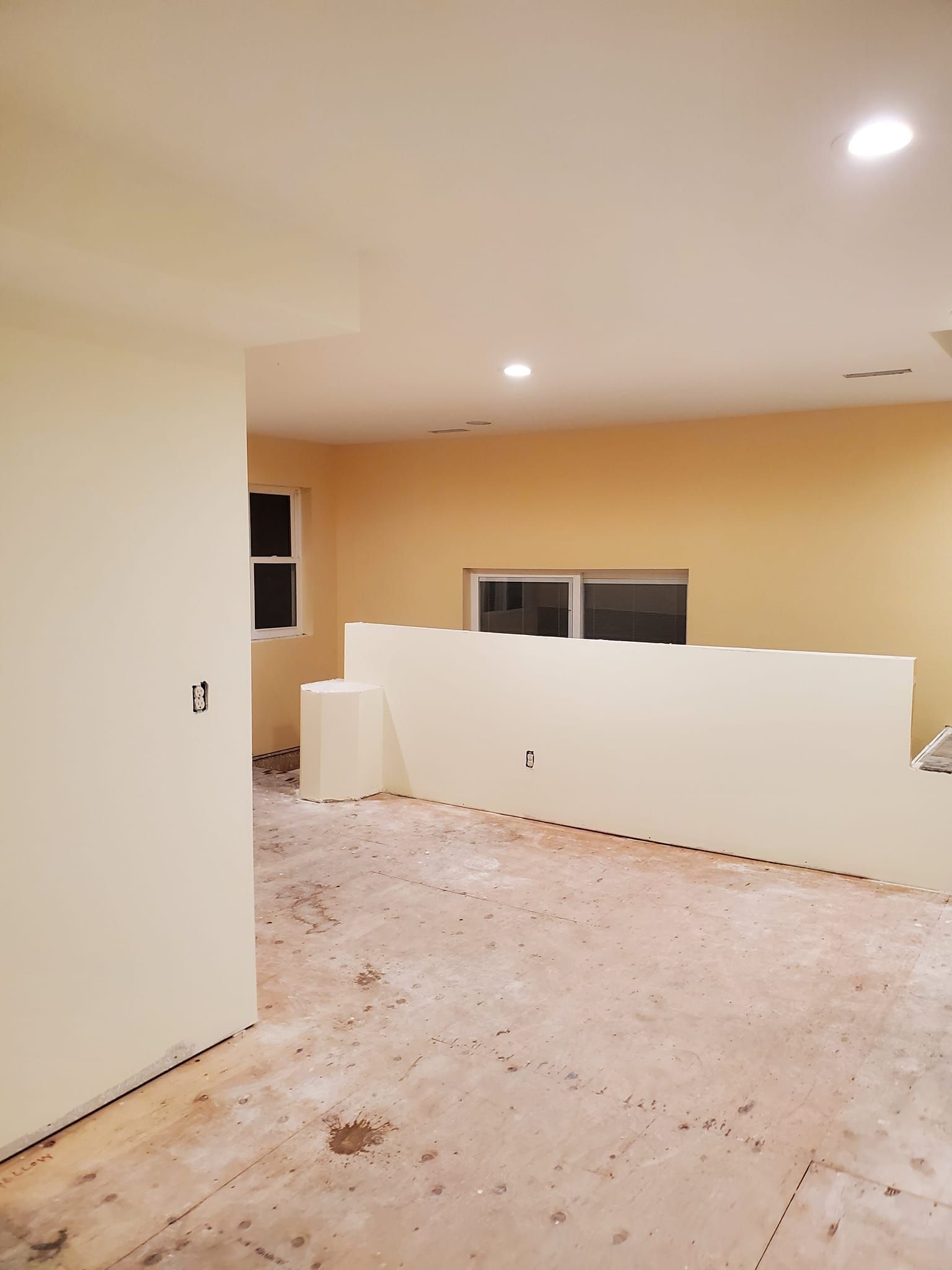 An empty room with white walls and wooden floors