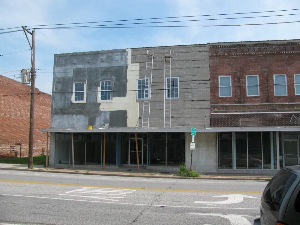 A car is parked in front of a building with a cross on it