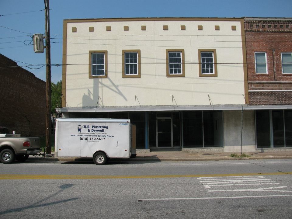 A truck is parked in front of a building that says bill smart