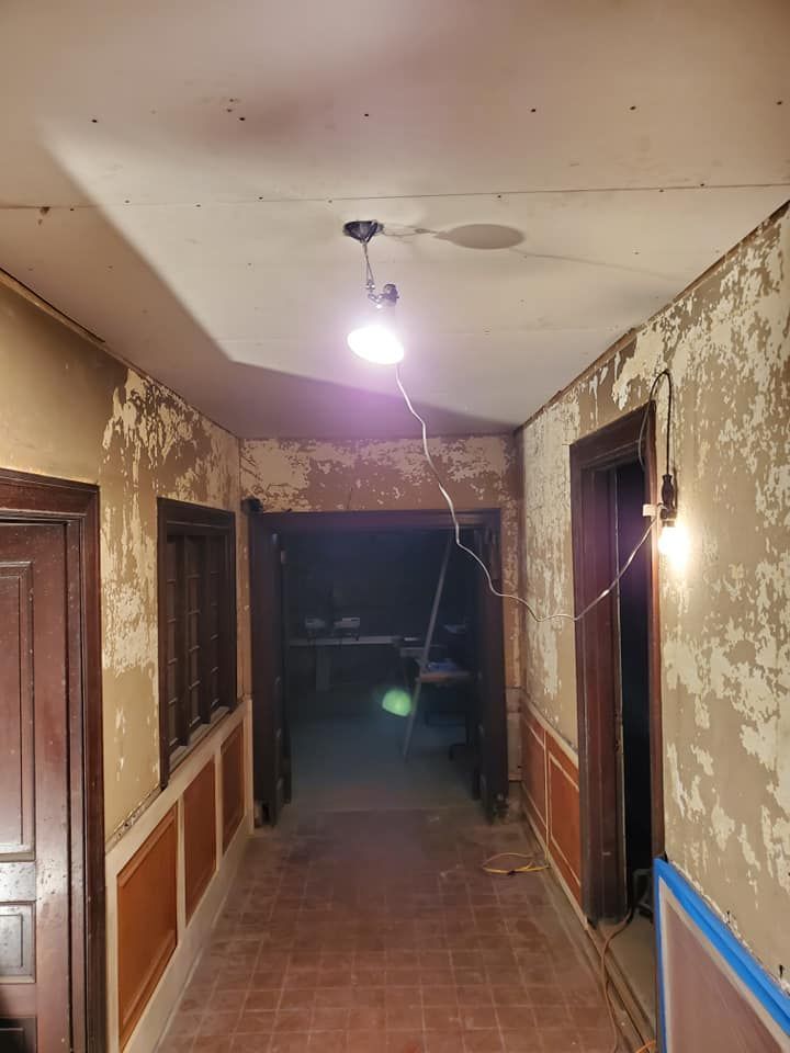 A long hallway with a light hanging from the ceiling.