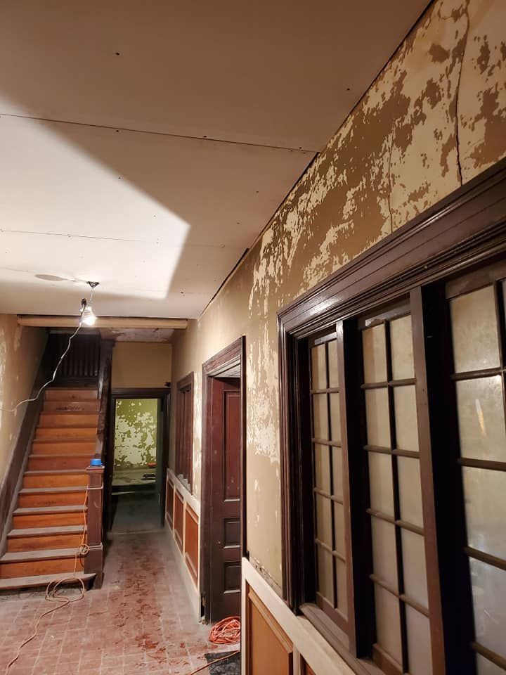 A hallway with a staircase and a lot of windows