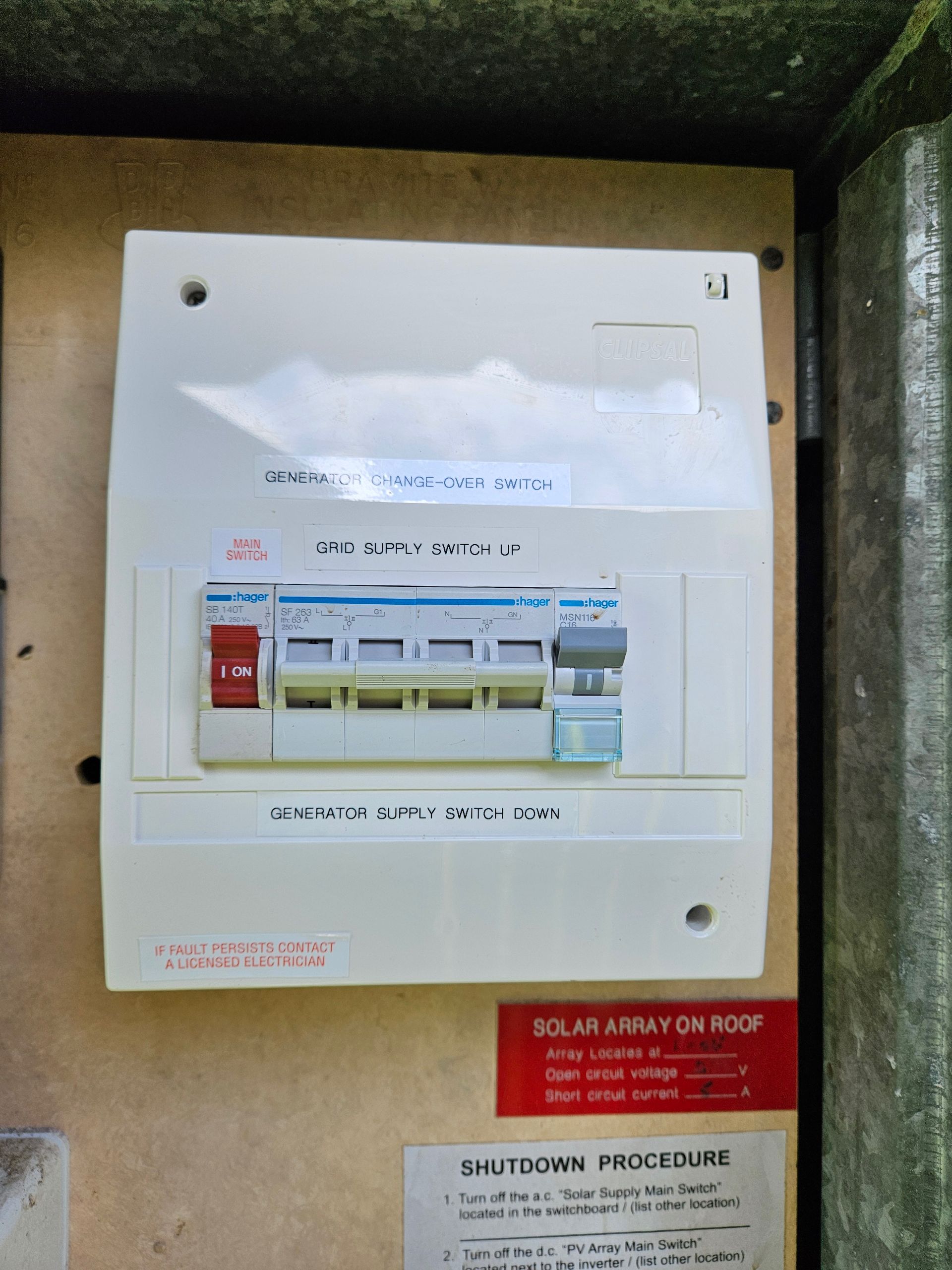 White electrical panel with switches, inside a metal cabinet.— Lit Energy in Seaforth, QLD