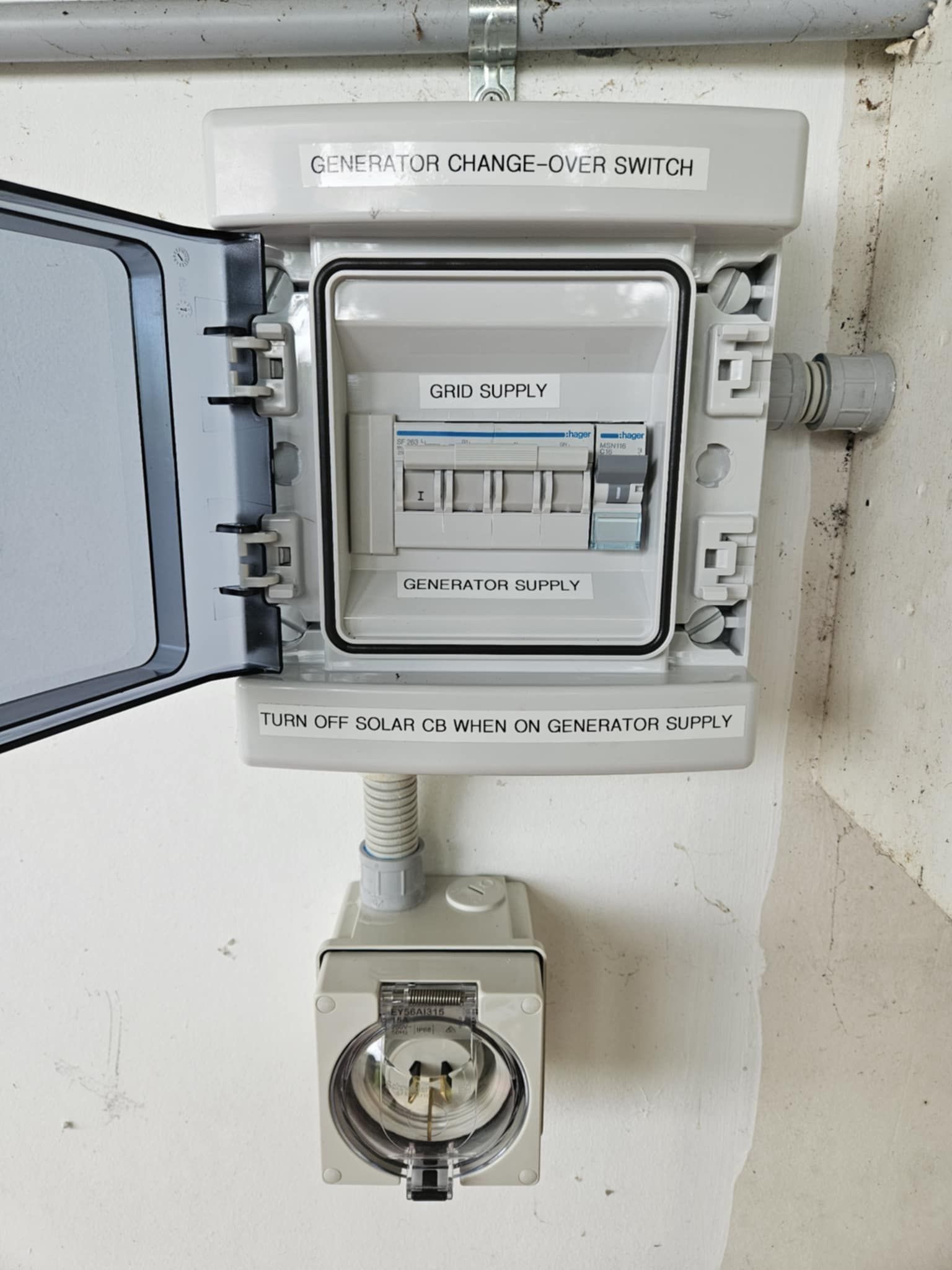 Generator Change-over Switch Box And Outdoor Socket On A White Wall With Labels, Conduit, And A Gray Cover  — Lit Energy in Seaforth, QLD
