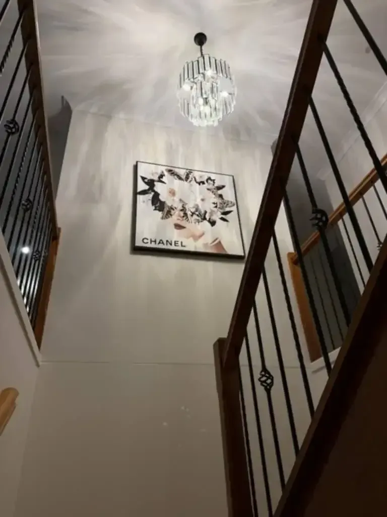 Stairwell With a Chandelier and a Chanel Artwork — Lit Energy in Marian, QLD