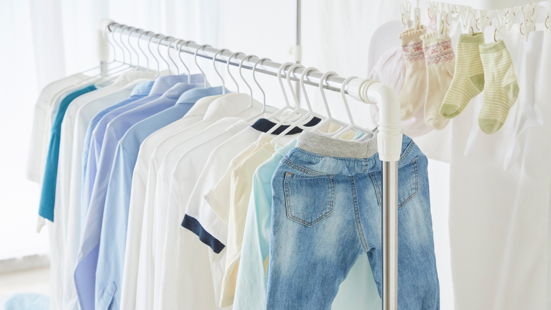 Bright office space with white desks, black chairs, and windows.