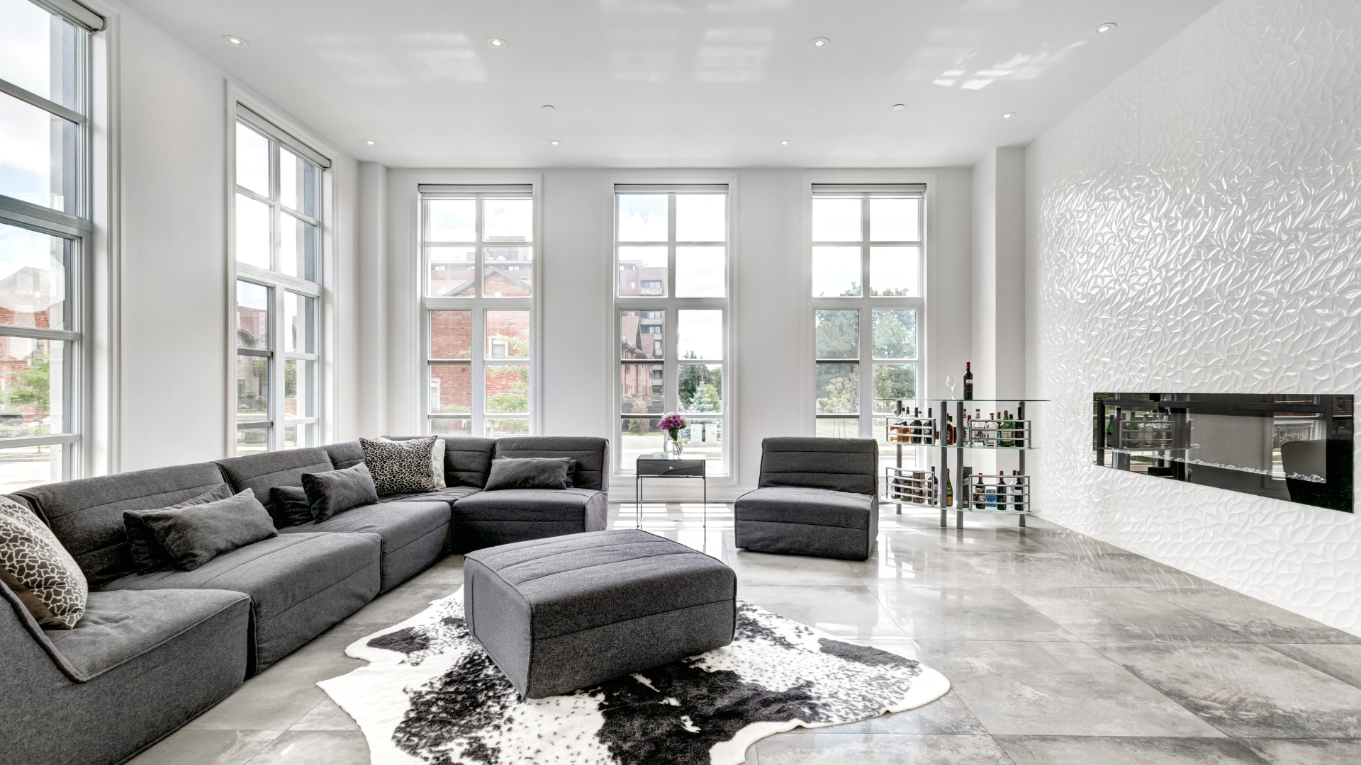 Bright kitchen with white cabinets, stainless steel appliances, and granite countertops.