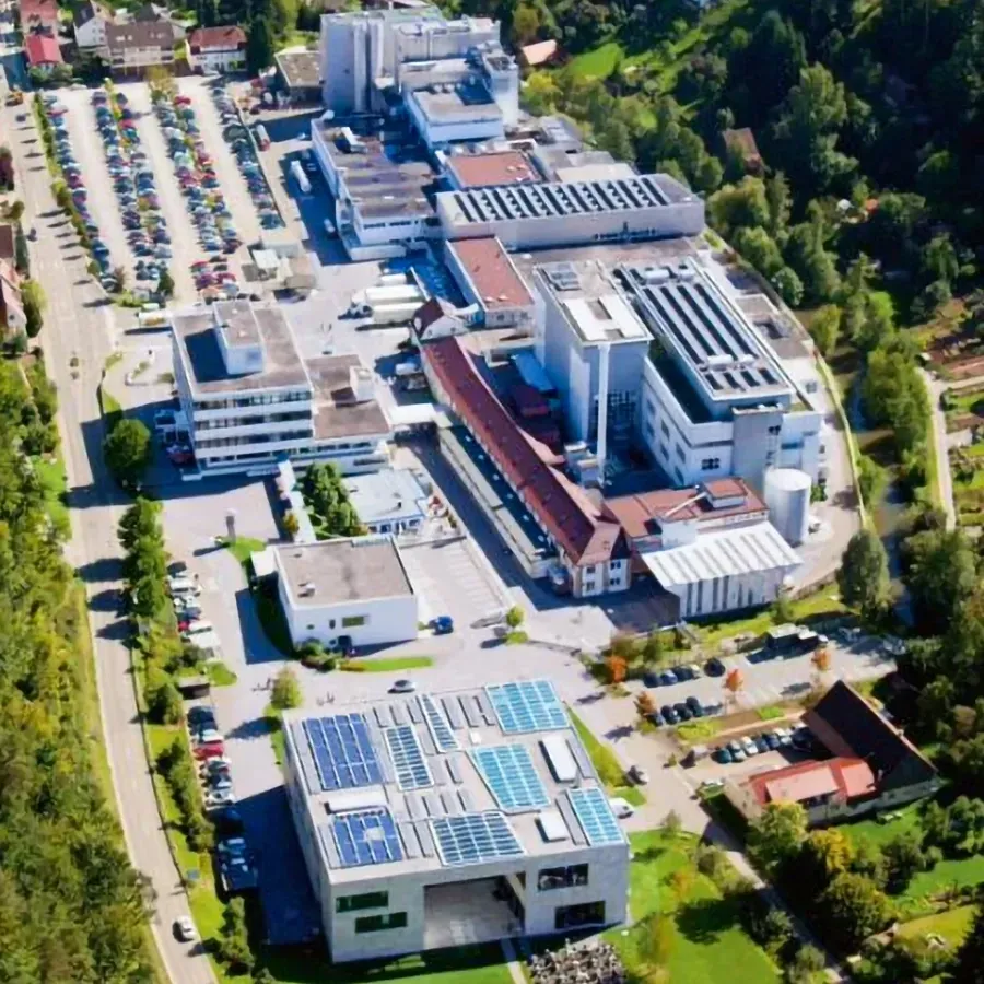 An aerial view of the Ritter Sport Company with solar panels on the roof