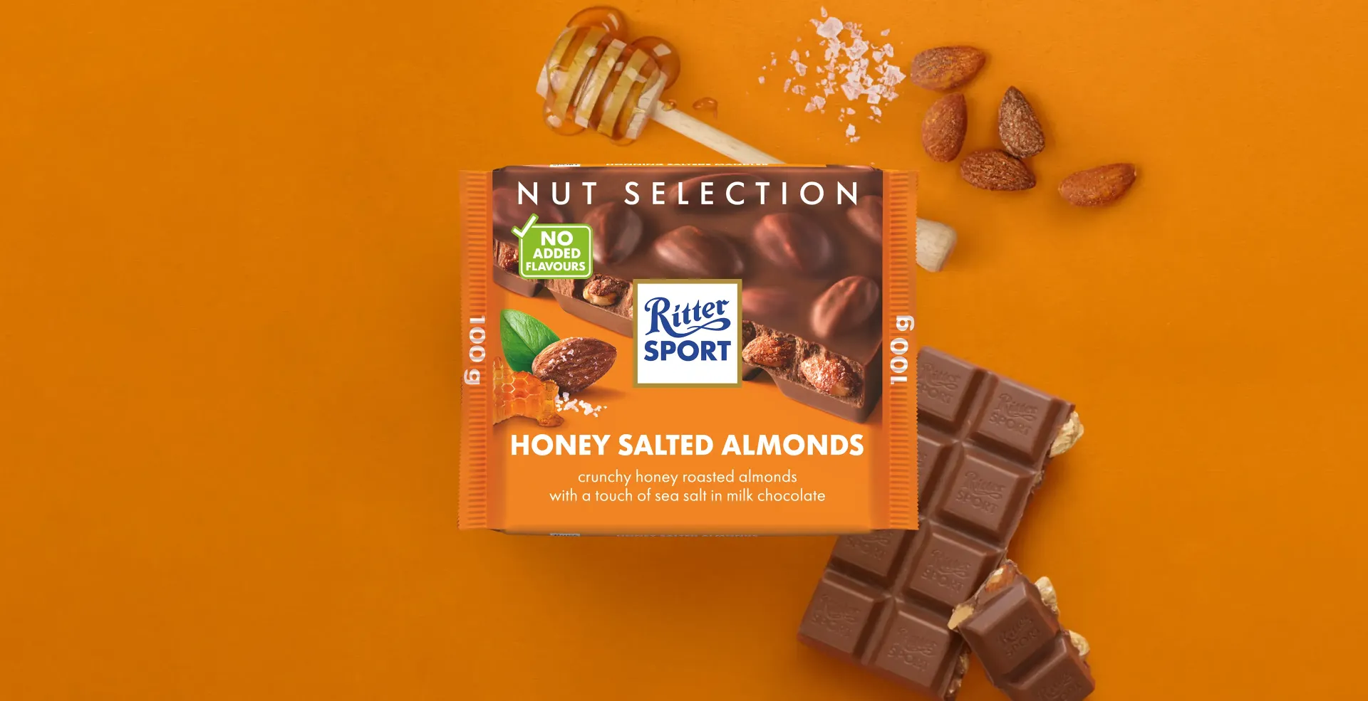 Ritter Sport chocolate bar packaging with cocoa beans, broken chocolate, and milk on a blue background.