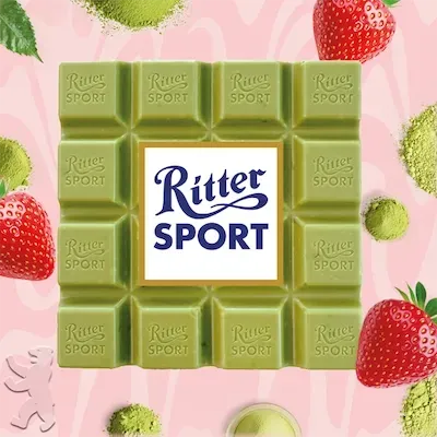 Green Matcha Bar on a light pink background with strawberries and matcha.