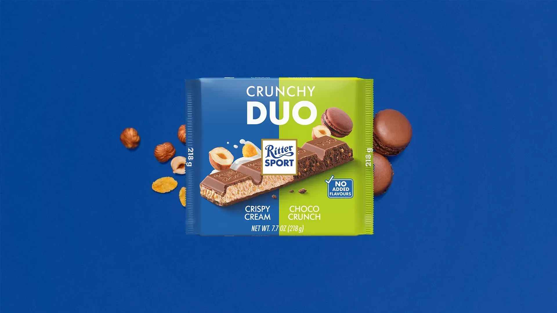 Ritter Sport chocolate bar packaging with cocoa beans, broken chocolate, and milk on a blue background.