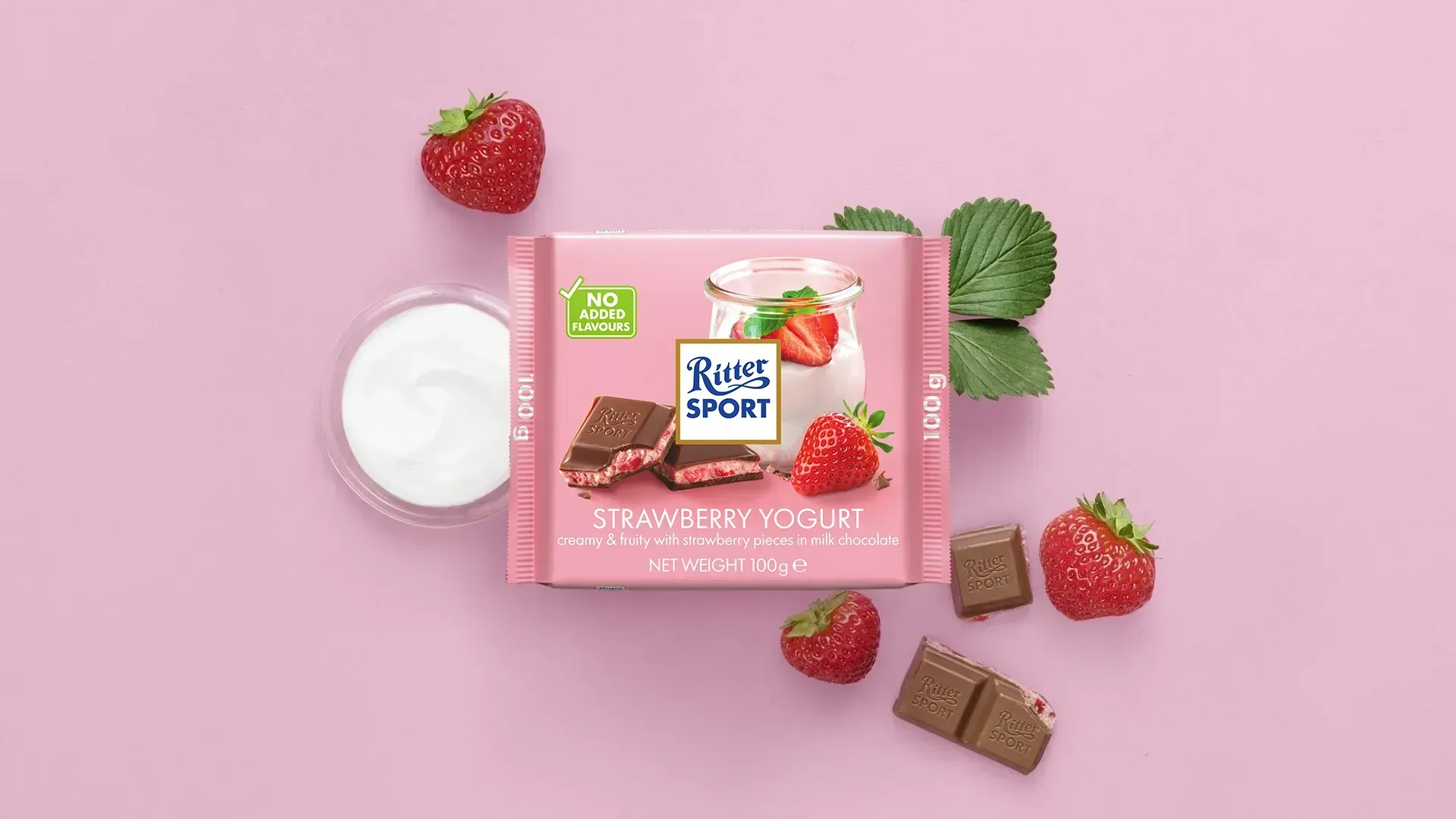 Ritter Sport chocolate bar packaging with cocoa beans, broken chocolate, and milk on a blue background.