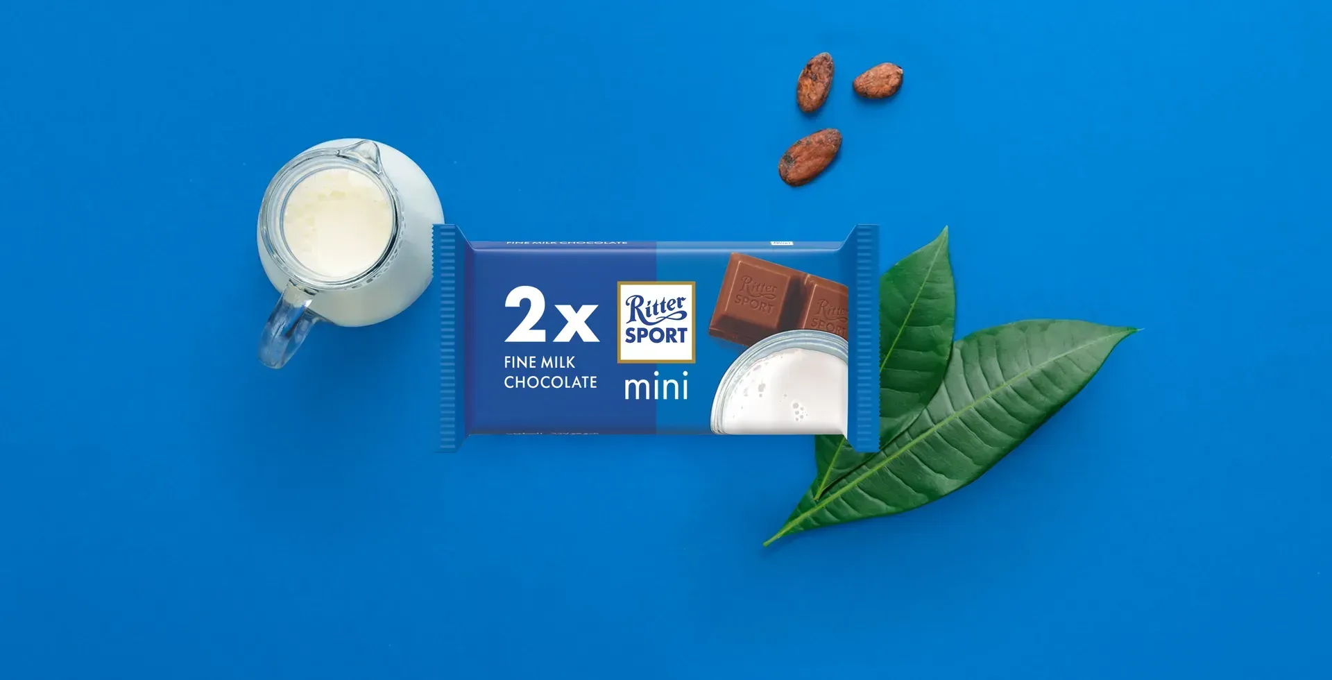 Ritter Sport chocolate bar packaging with cocoa beans, broken chocolate, and milk on a blue background.