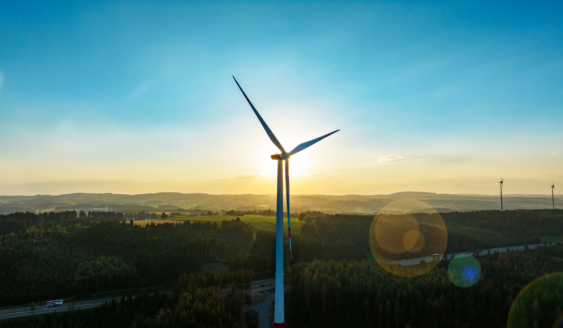 An aerial view of a wind turbine at sunset