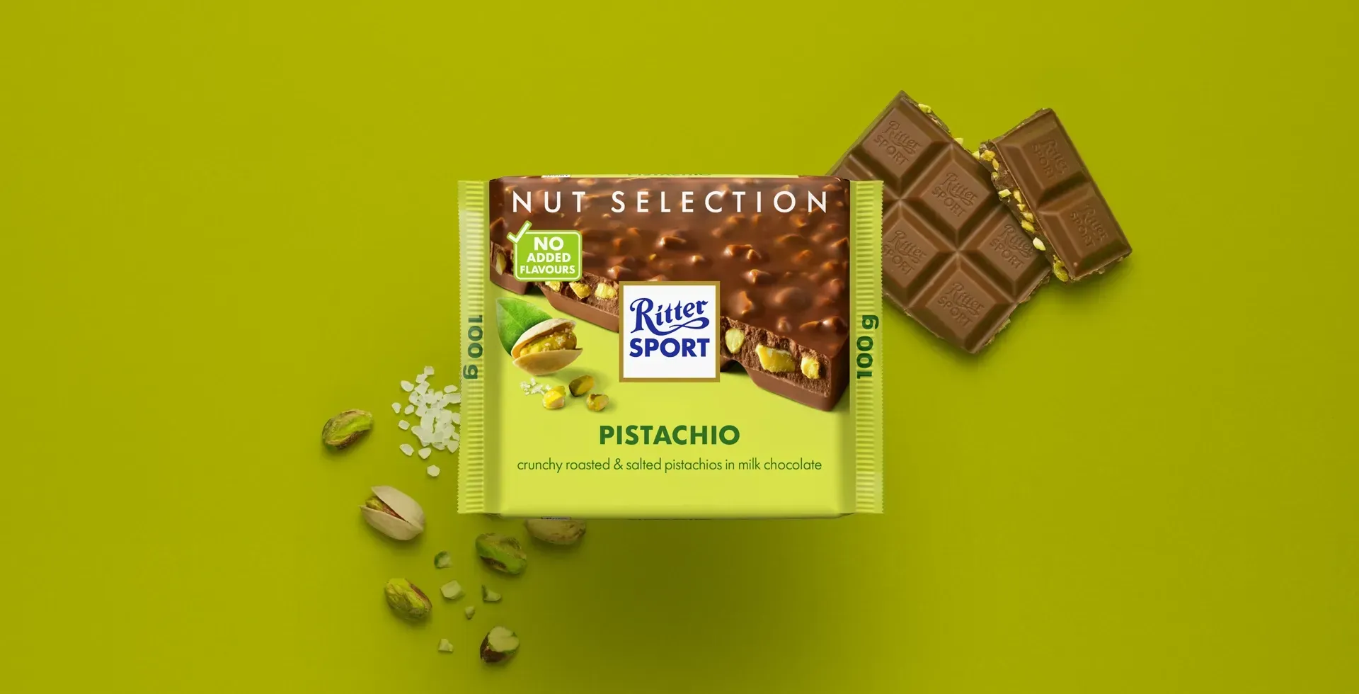 Ritter Sport chocolate bar packaging with cocoa beans, broken chocolate, and milk on a blue background.
