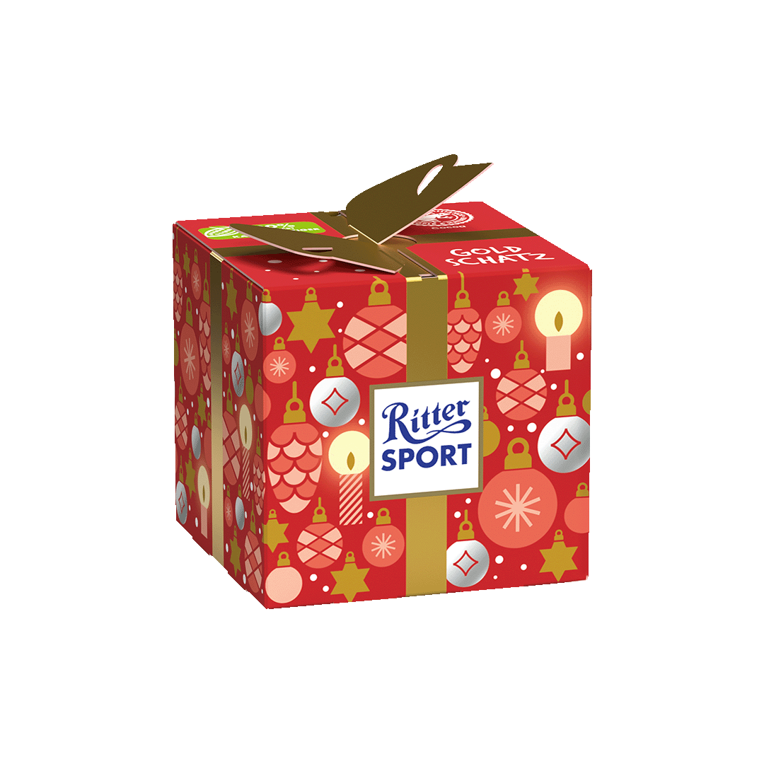 Eine rote Ritter Sportbox mit Weihnachtsschmuck darauf