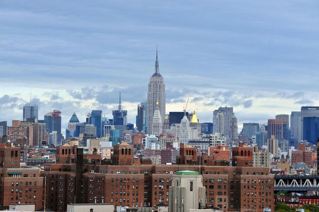 A city skyline with the empire state building in the foreground
