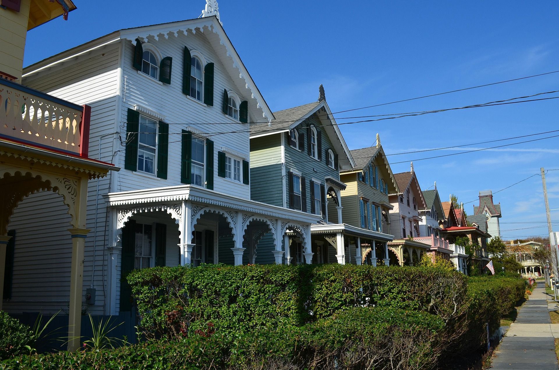 A row of houses with green shutters on a sunny day