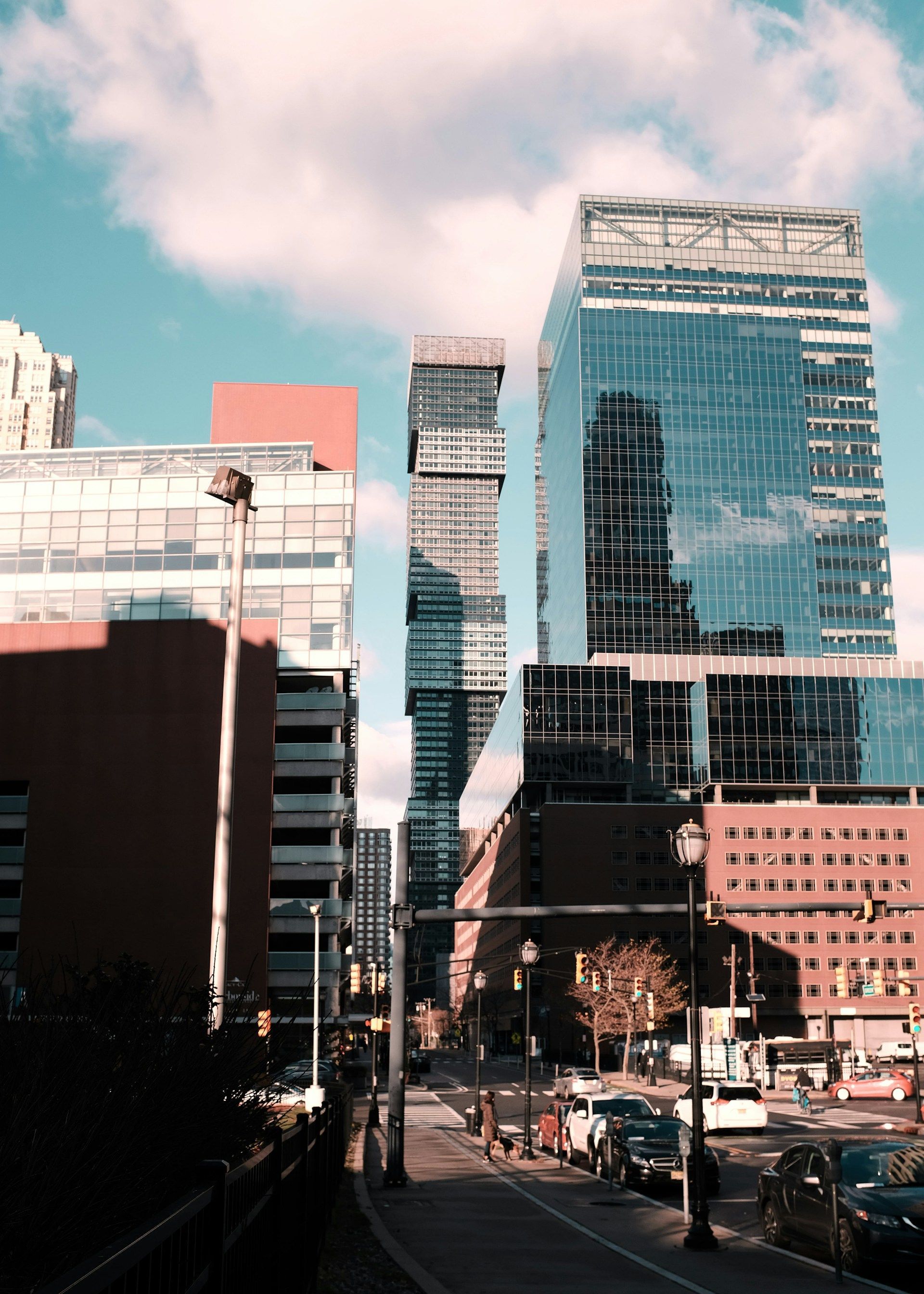 A city street with a lot of tall buildings in the background