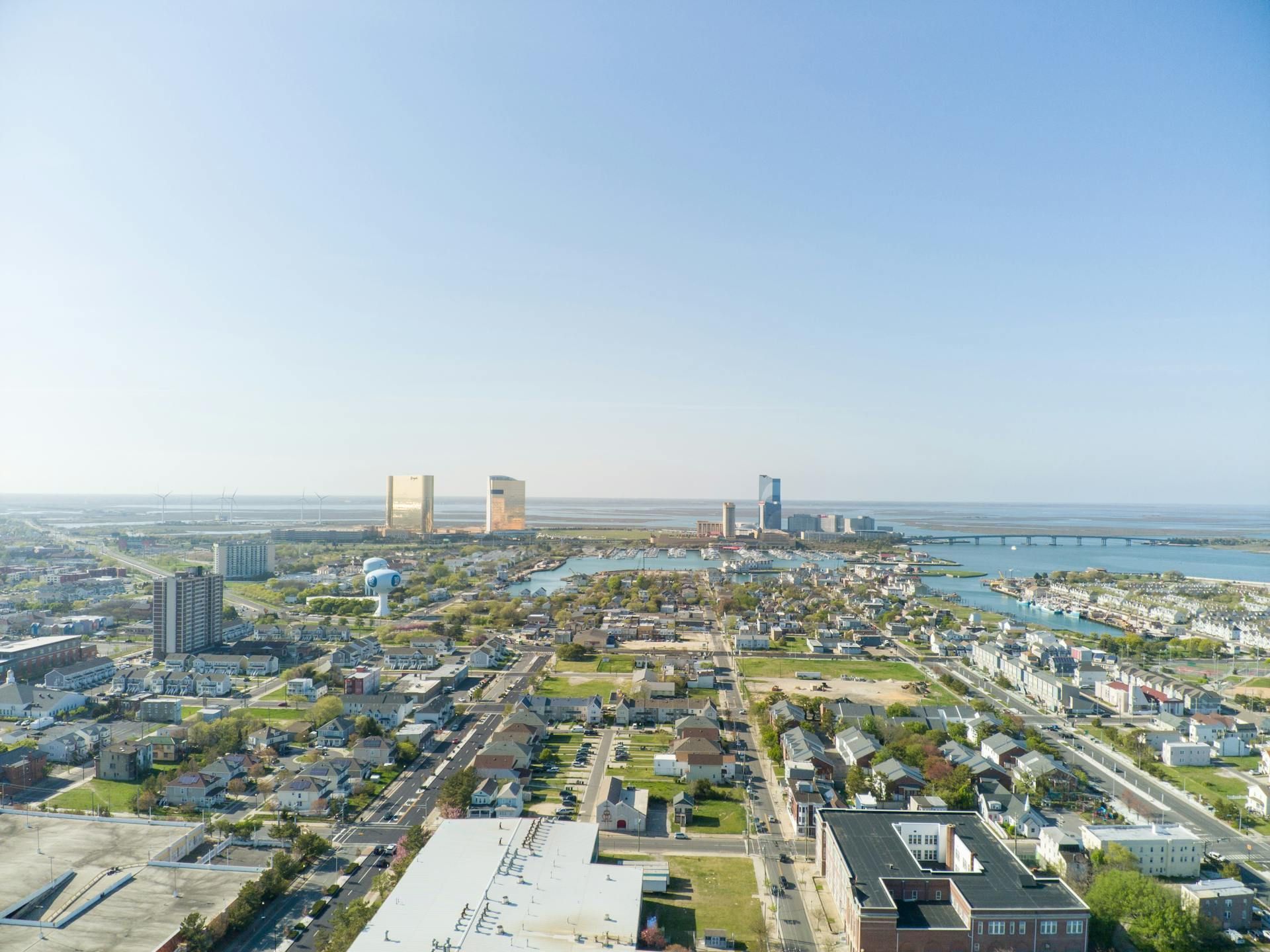 An aerial view of a city with a large body of water in the background.