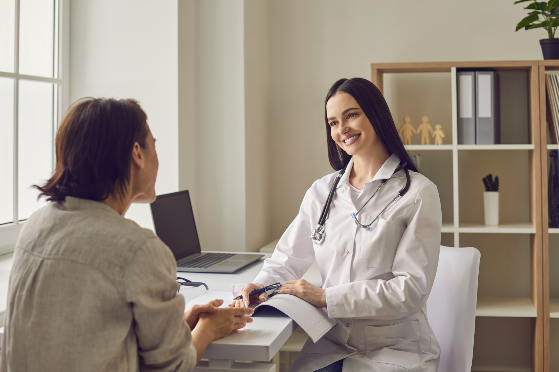 Doctor smiling at patient in an office.