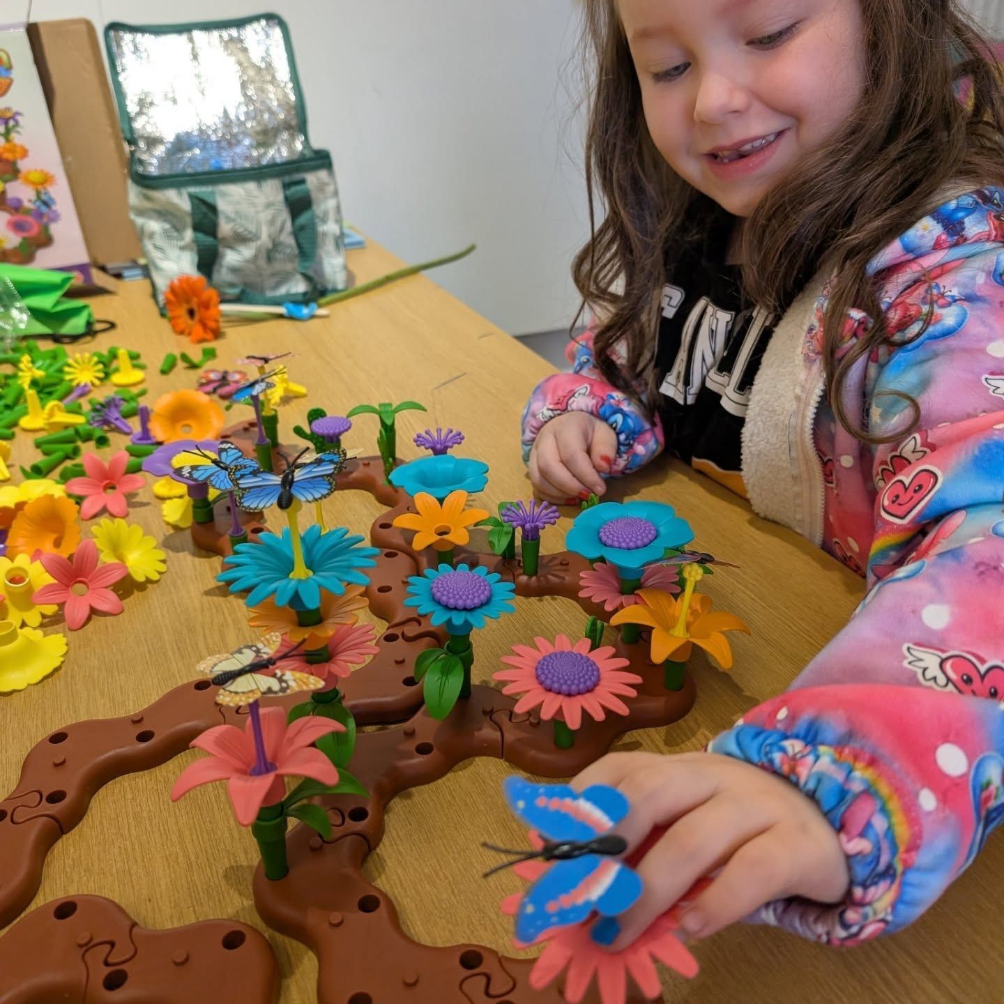 Young girl creating a flower garden