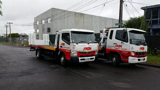 A tow truck loaded with silver car in Auckland