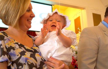 happy baby in white, baptism