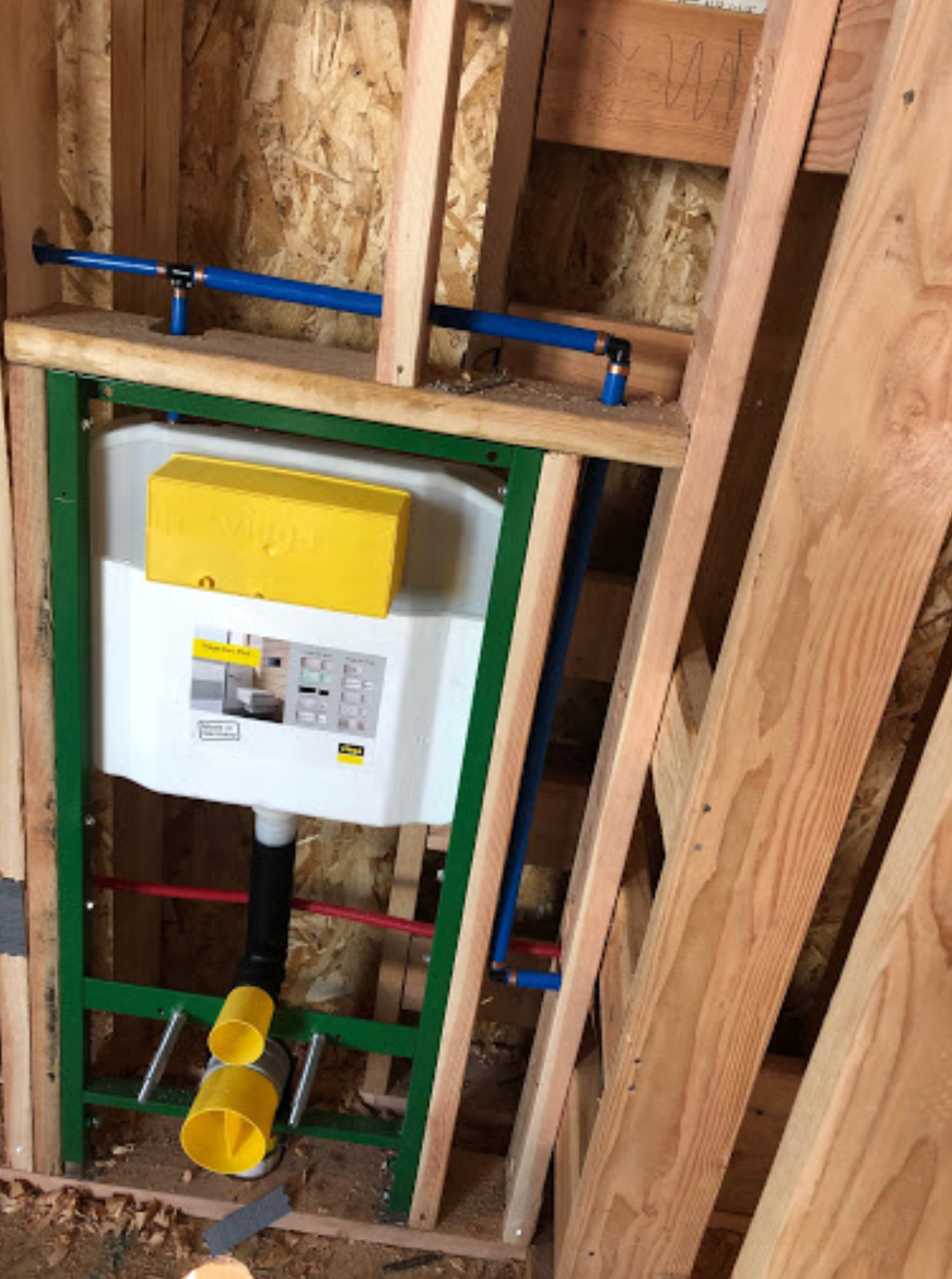 A toilet is built into a wall in a wooden frame