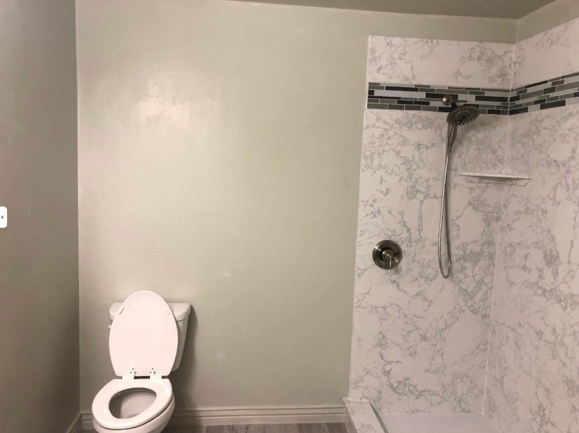 There is a toilet and a shower in the bathroom.