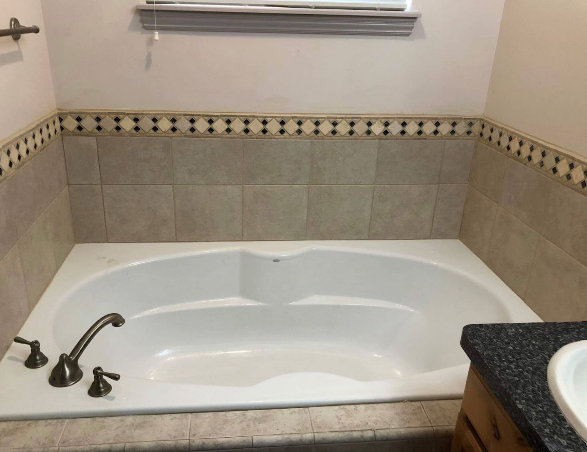 A bathtub in a bathroom next to a sink