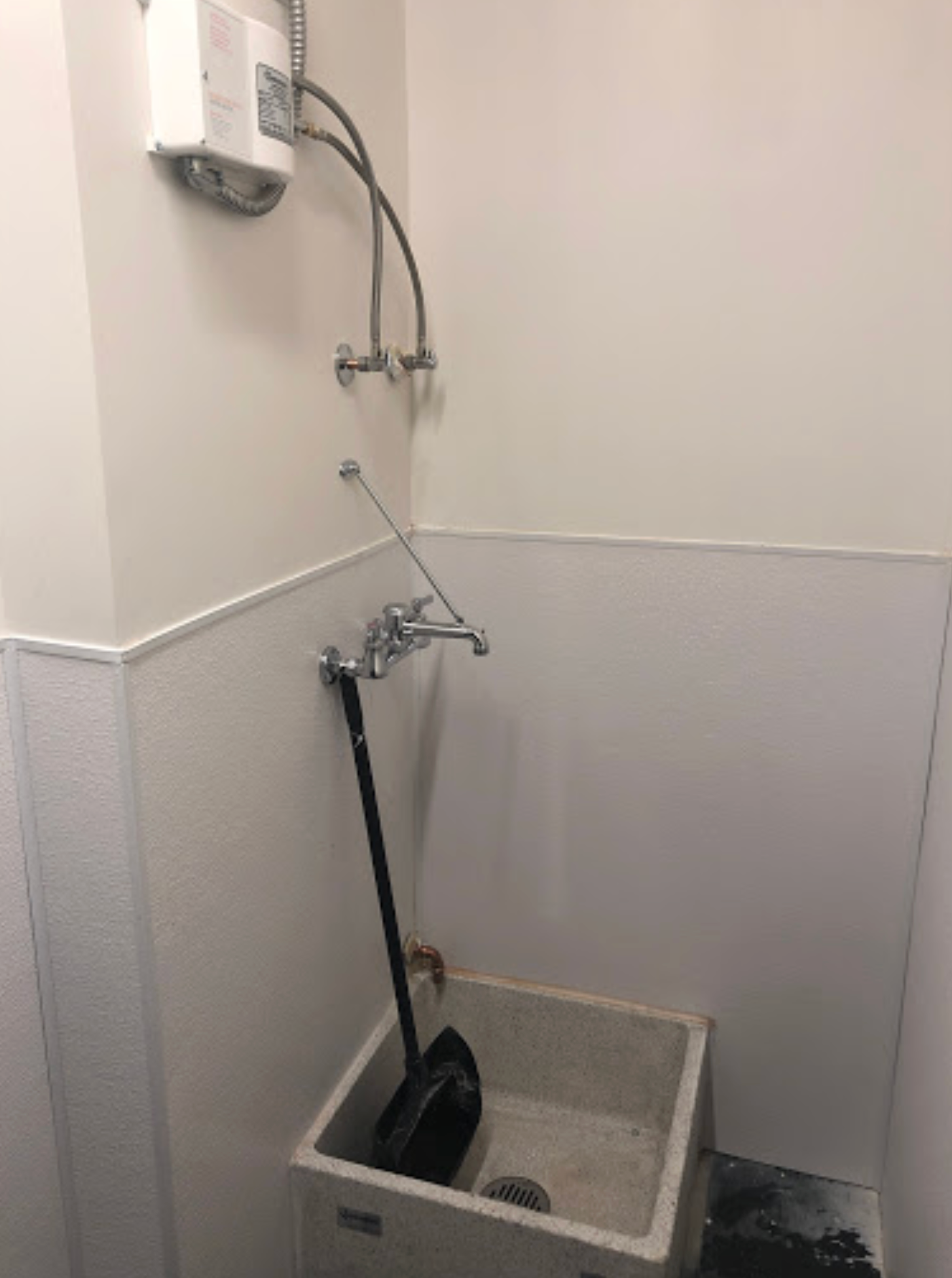 A bathroom with a sink and a faucet.