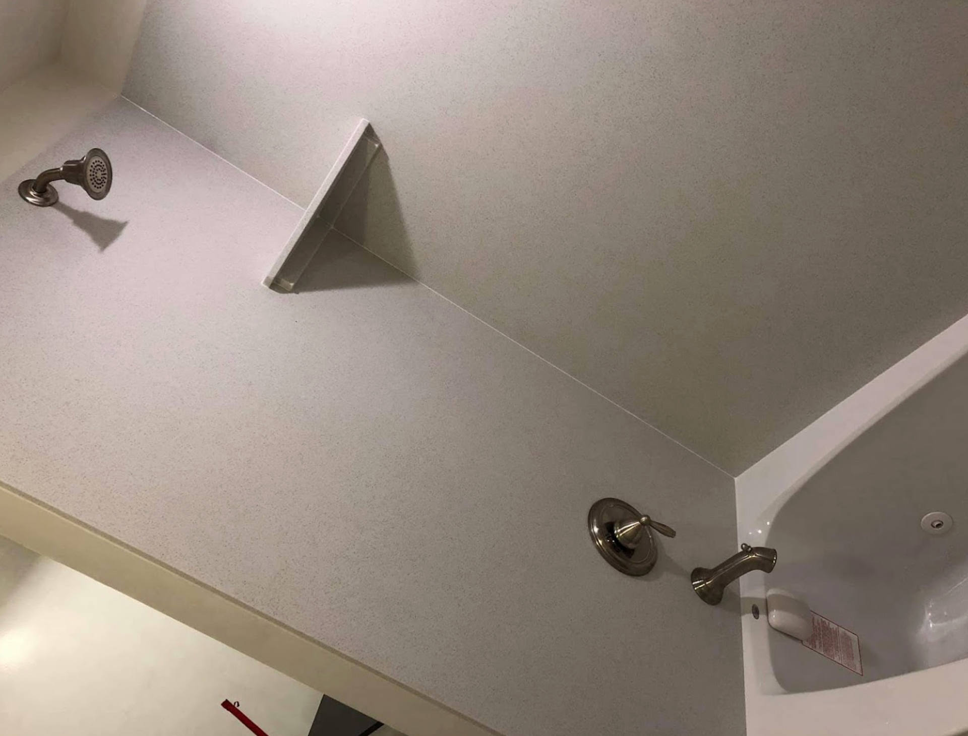 A bathroom with a shower head and a bathtub.