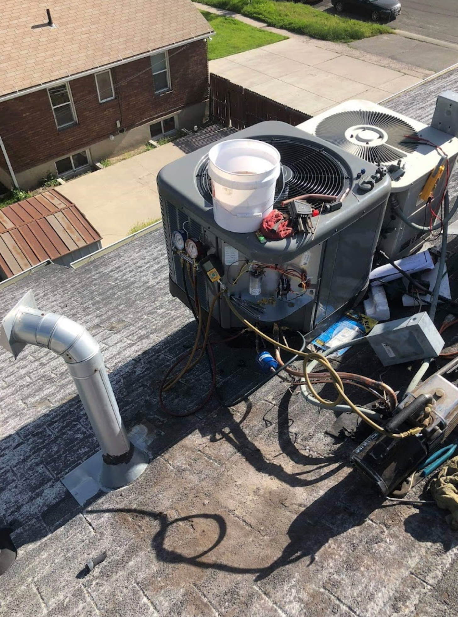 An air conditioner is sitting on top of a roof.