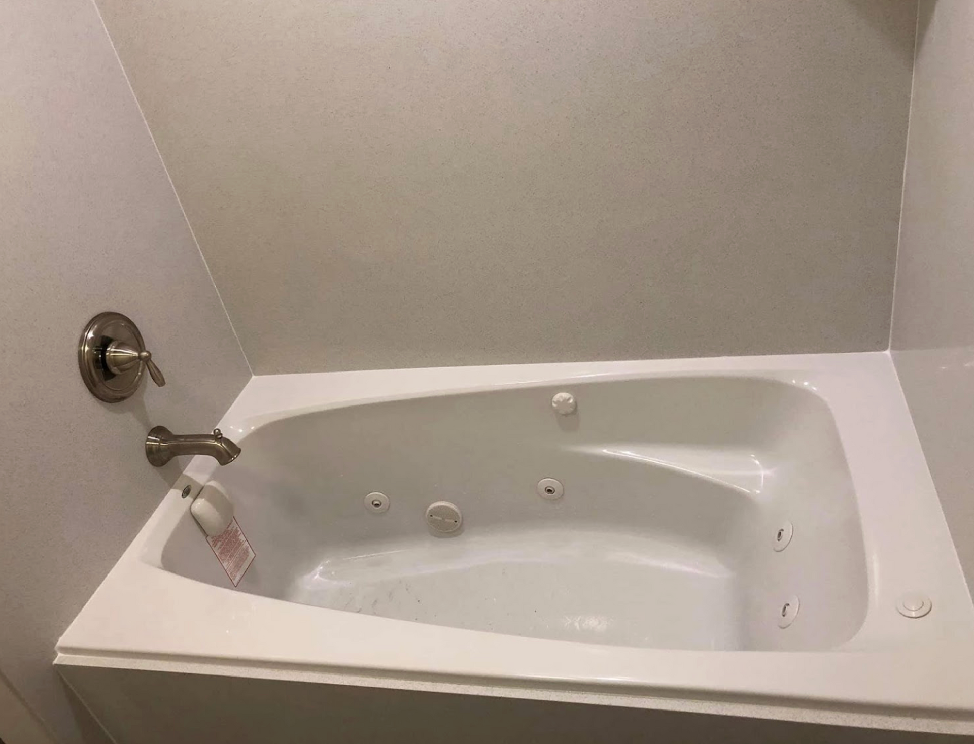 A white jacuzzi tub is sitting in a bathroom next to a shower.