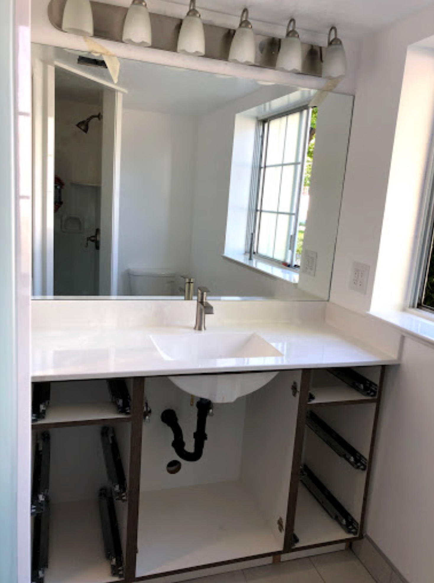 A bathroom with a sink and a large mirror