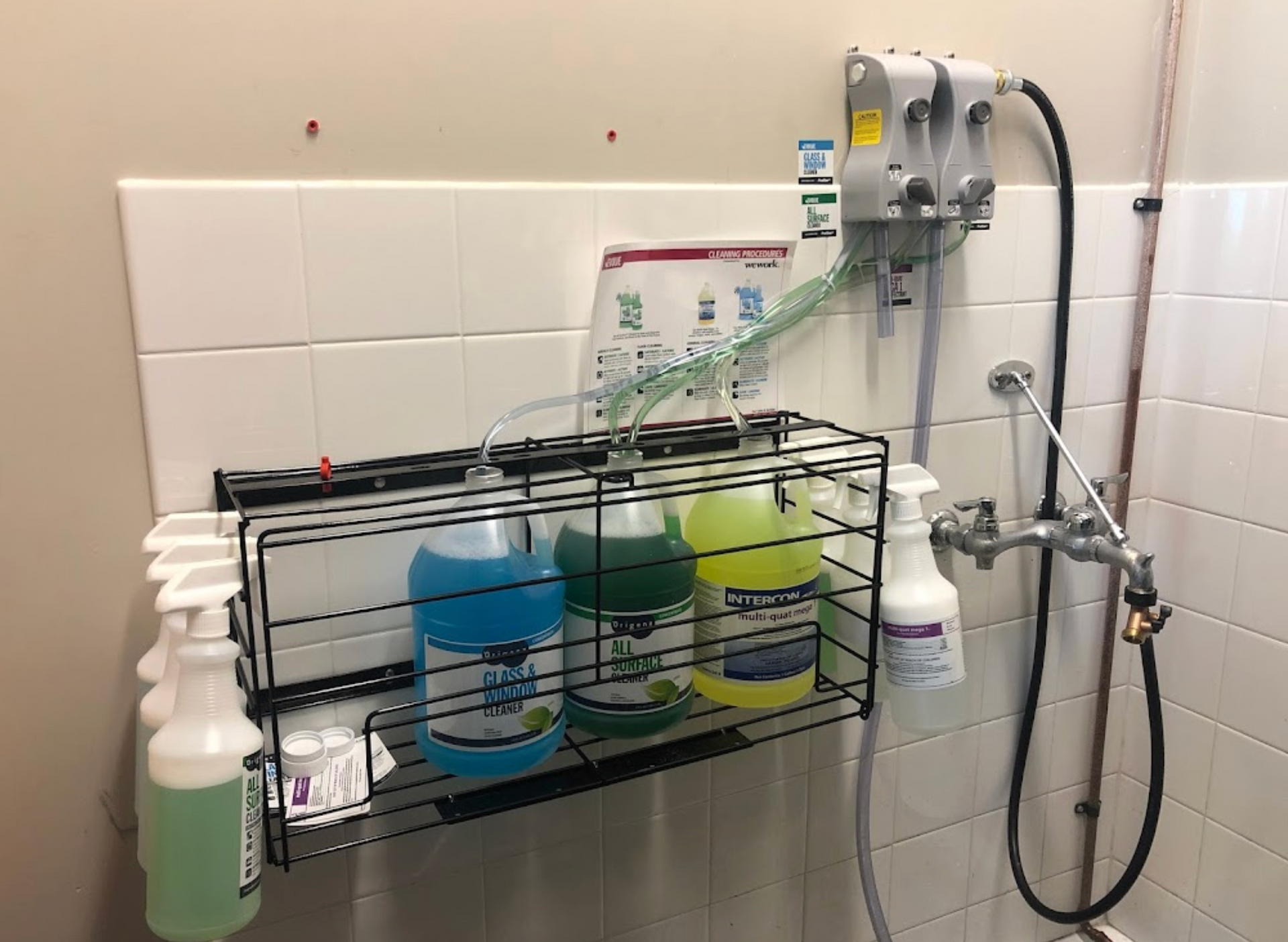 A bathroom with a shower and a shelf with bottles of cleaning supplies on it.