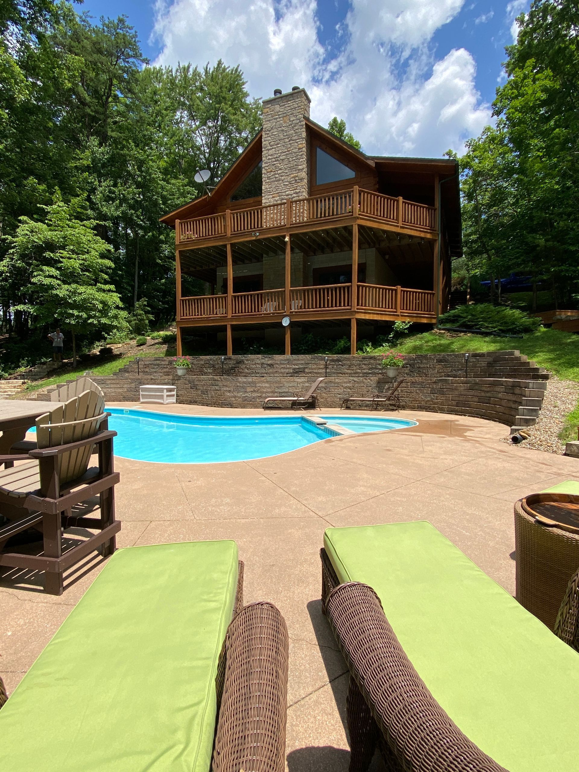 A large house with a swimming pool in front of it