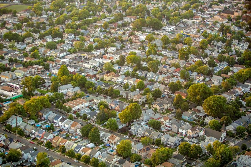 Skyline of Jersey City, NJ, across the water on a clear, sunny day. Skyscrapers, blue sky.