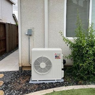 A house with a large air conditioner on the side of it.