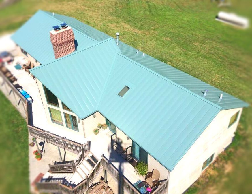 An aerial view of a house with a blue roof